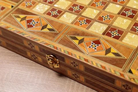 An entertaining backgammon game. Checkers, cubes, handmade board Stock Photos