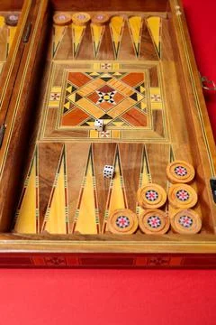 An entertaining backgammon game. Checkers, cubes, handmade board Stock Photos