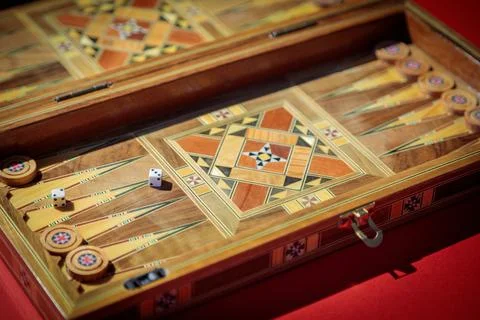 An entertaining backgammon game. Checkers, cubes, handmade board Stock Photos