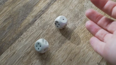 Entertainment Game Concept. A Hand Throws Two Dice on a Wooden Table. Close-up o Stock Footage 141666707