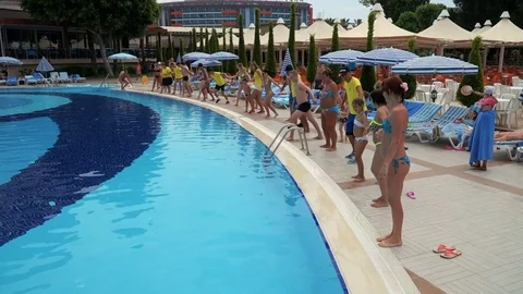 Entertainment program near the pool at the resort. A crowd of people on comma Stock Footage 77293231