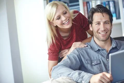 Entertainment through technology. an attractive young woman looking over her Stock Photos