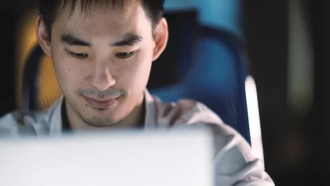 Enthusiastic about work, young Asian businessman working on a laptop, working at Stock Footage 124958757