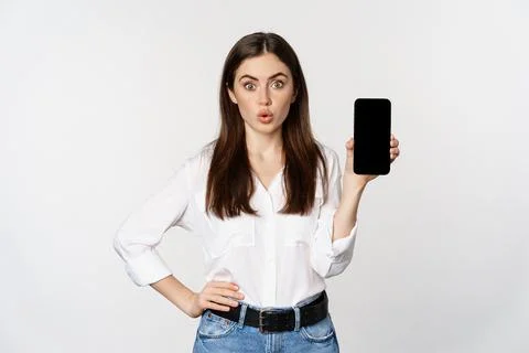 Enthusiastic corporate woman demonstrating website, mobile phone screen, showing Stock Photos