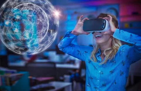 Enthusiastic female computer programmer testing virtual reality simulator 写真素材