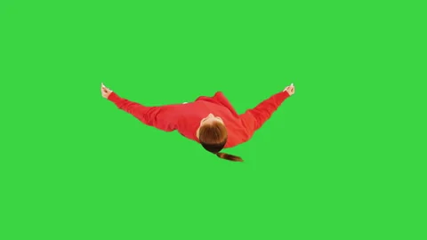 Enthusiastic female dancer performs some contemporary dance movements on a Green Stock Footage 219468560
