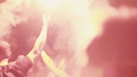 Enthusiastic front row crowd light a flair 100p Stock Footage 76621993