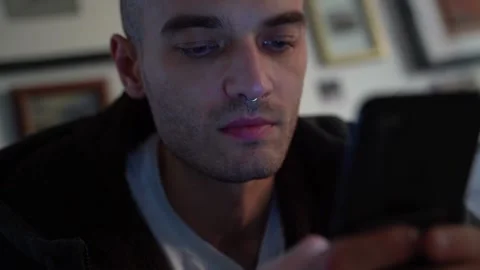 Enthusiastic man looking at the phone close-up Video stock 224331737