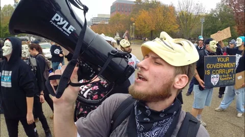 An enthusiastic protester from the group Anonymous uses a bullhorn Stock Footage 56703700