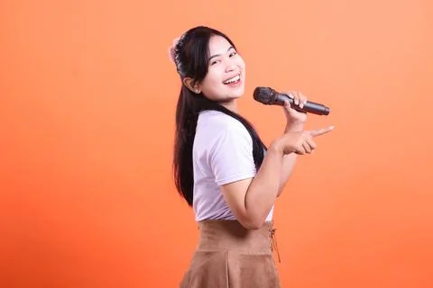 Enthusiastic Singer with Microphone Stock Photos