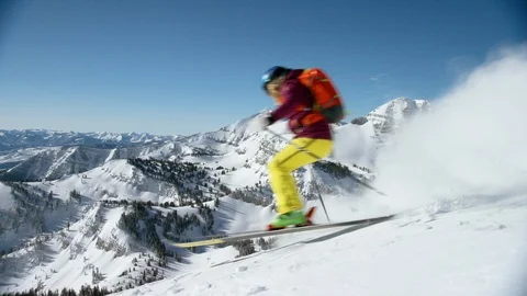 Enthusiastic skier heads down the mountain on the fresh powder snow Stock Footage 116746288