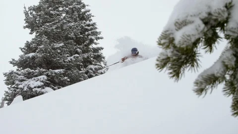 Enthusiastic skier skiing down the steep mountain slope during winter Stock Footage 116785880