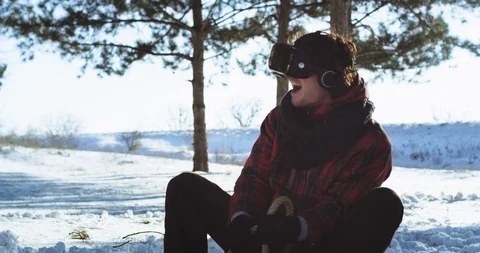 Enthusiastic smiling large young guy outside in a winter time using a virtual Video stock 111958968