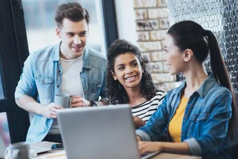 Enthusiastic three students exchanging ideas Foto stock