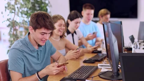 Enthusiastic young guy undergoing training in mobile applications development Stock Footage 310315707