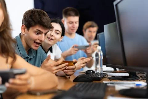Enthusiastic young guy undergoing training in mobile applications development 写真素材