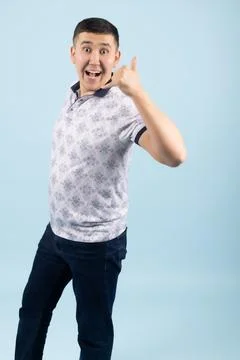 Enthusiastic Young Man Making Call Me Hand Gesture Stock Photos