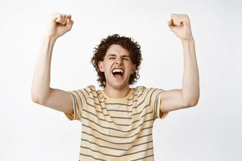 Enthusiastic young man shouting and fist pump, chanting, rooting for win Stock Photos