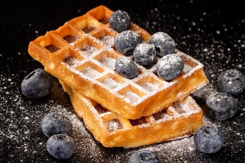 An enticing image of soft belgian waffles, perfectly paired with plump bluebe Stock Photos