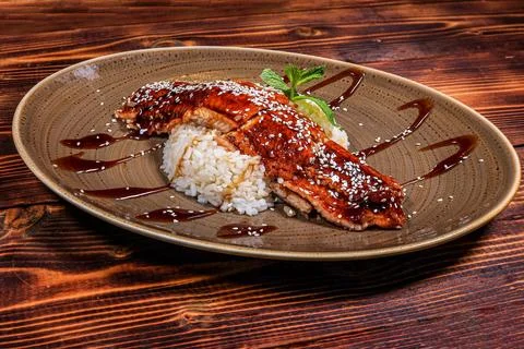 An enticing serving of teriyaki-glazed eel, delicately sprinkled with sesame  Stock Photos