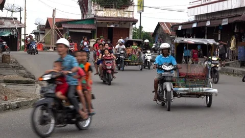 Entire families riding motor scooters without helmets, Sumatra, Indonesia Stock Footage 91591184