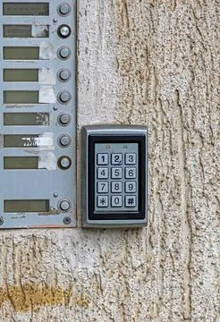 Entrance door that utilizes a numeric code to unlock it outside on building wall Stock Photos