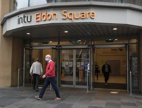 Entrance exit to intu Eldon Square shopping centre with people in face masks Stock Photos