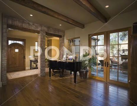 Entrance foyer with beamed ceiling and grand piano Stock Photos