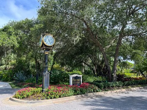 The entrance with a sign and Rolex Clock to Trump National Golf Course Club H Stock Photos
