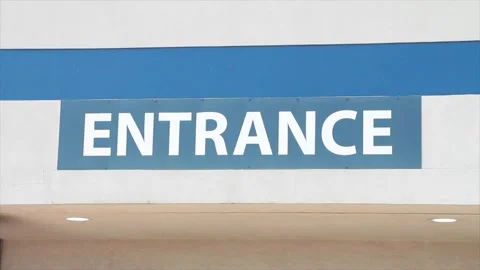 Entrance writing caption text facade sign word in white on blue outside exterior Stock Footage 250274118