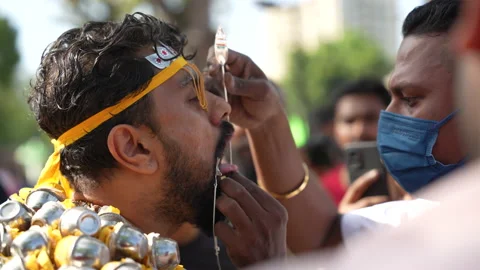 An Entranced Devotee Has His Cheeks And Tongue Skewered At Thaipusam Festival Stock Footage 234066932