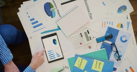 Entrepreneur Analyzing Financial Graphs On Digital Tablet By Charts 4K Stock Footage 92369946