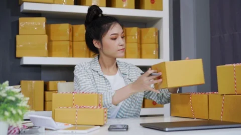 Entrepreneur checking parcel boxes in her own job shopping online business Stock Footage 97458894