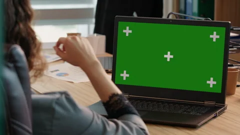 Entrepreneur checking reading and aswering email on green screen laptop Stock Footage 295811292
