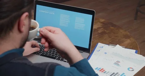 Entrepreneur on a coffee break comparing data from official papers and his Stock Footage 105400826