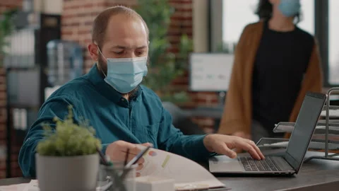 Entrepreneur comparing information on papers and laptop Stock Footage 163800483