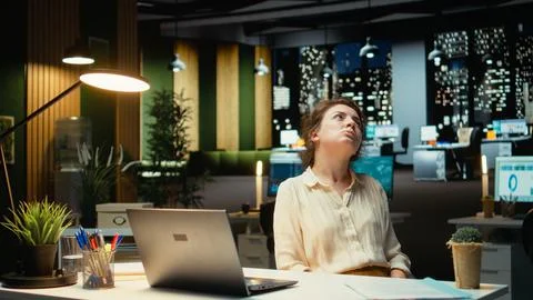 Entrepreneur contemplating on a complex problem in a dark office late at night Stock Photos