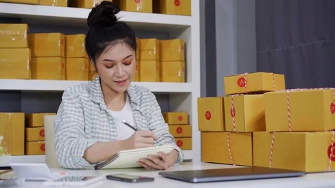 Entrepreneur counting parcel boxes in her own job shopping online business Video stock 97483711