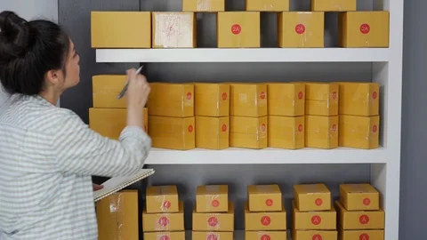 Entrepreneur counting parcel boxes in her own job shopping online business Stock Footage 97485751