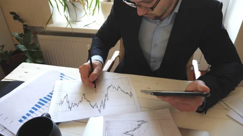 Entrepreneur developing a business project and analyzing statistical data Stock Footage 135023442