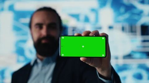 Entrepreneur explores virtual intelligence with green screen on device Stock Footage 310967834
