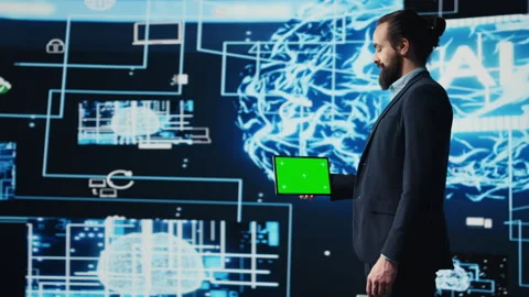Entrepreneur explores virtual intelligence with green screen on device Stock Footage 310972083