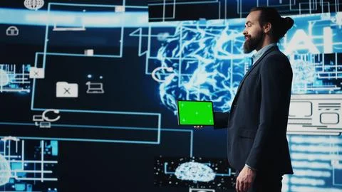 Entrepreneur explores virtual intelligence with green screen on device Foto stock