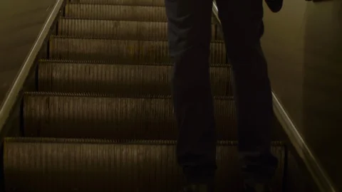 Entrepreneur going up on escalator Stockbeeldmateriaal 120663572