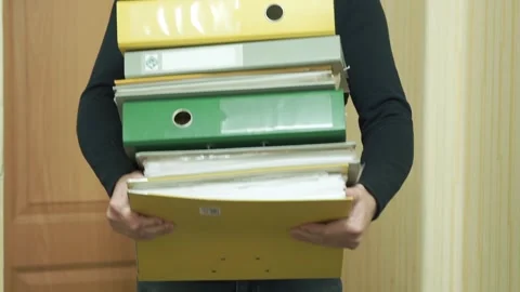 An entrepreneur holds a large stack of financial documents in his hands 動画素材 286101591