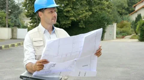 Entrepreneur looking at construction map Stock Footage 14831842