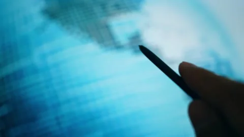 Entrepreneur pointing at a glowing digital globe screen. Vídeos de archivo 338054341