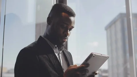 Entrepreneur reading news on tablet in elevator Stock Footage 121151216