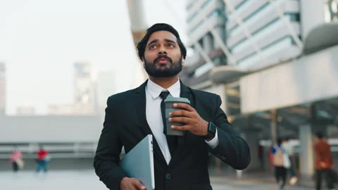 Entrepreneur sipping coffee while going to work by downtown Stock Footage 303736314