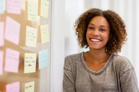 Entrepreneur smiling in front of her task cards Stock Photos